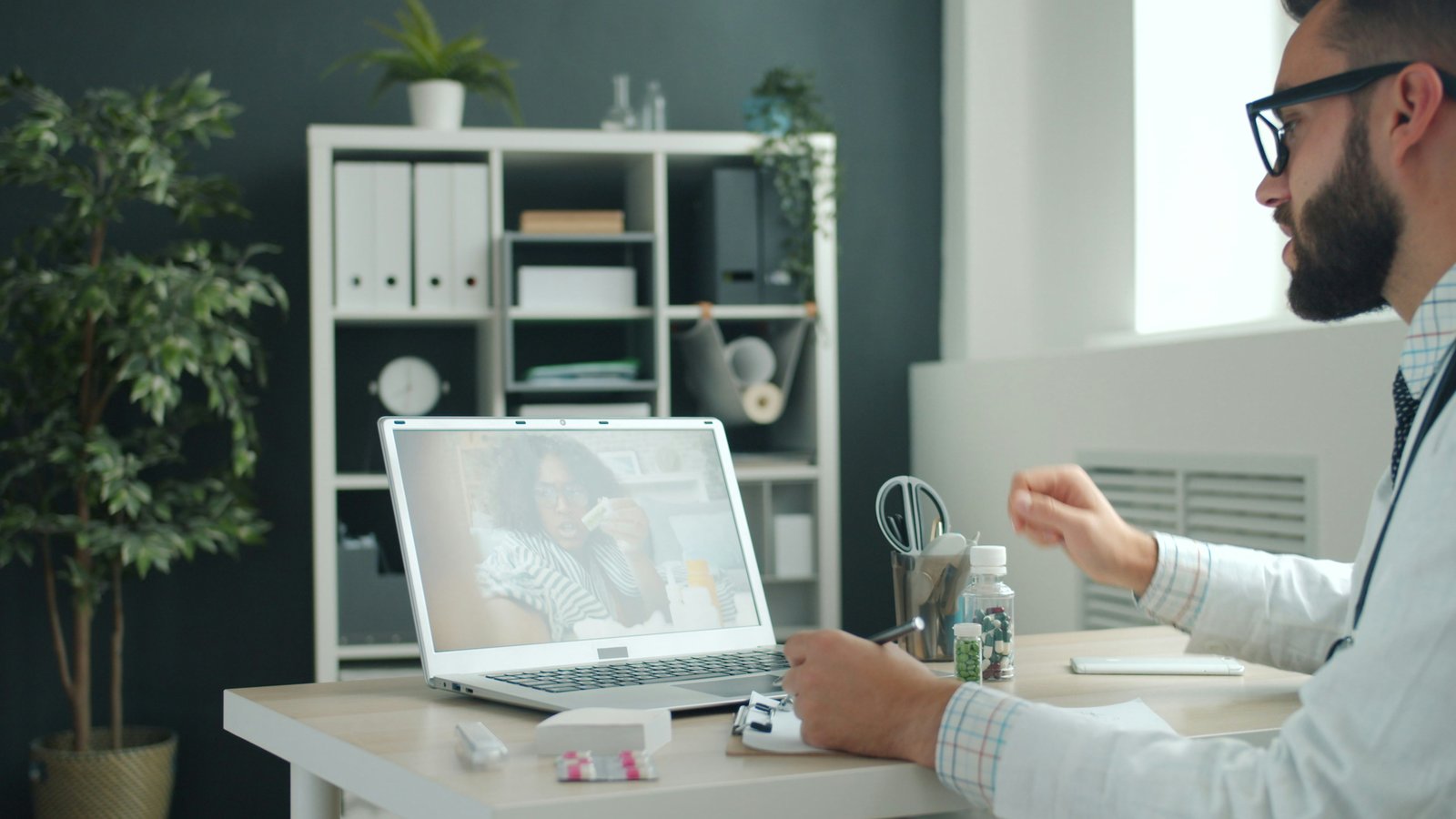 A physician connecting with a patient through a telehealth consultation